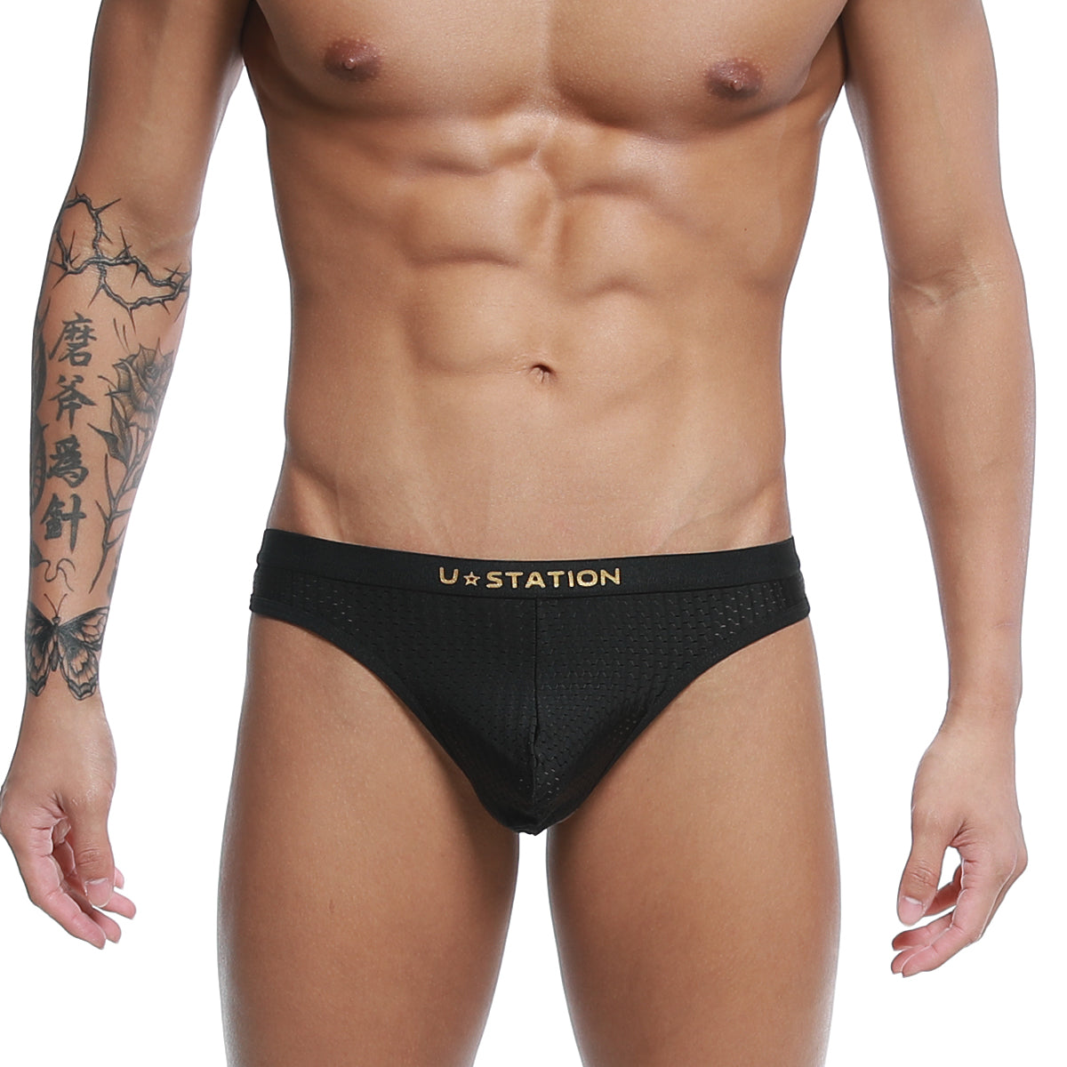 Black ustation seduction thong briefs with gold logo and breathable mesh fabric front view