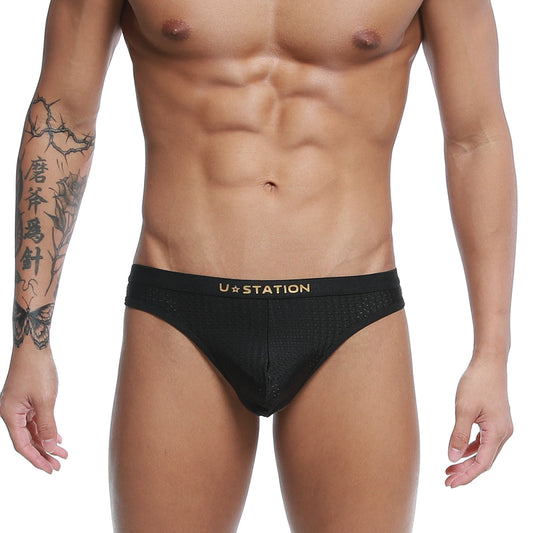 Black ustation seduction thong briefs with gold logo and breathable mesh fabric front view