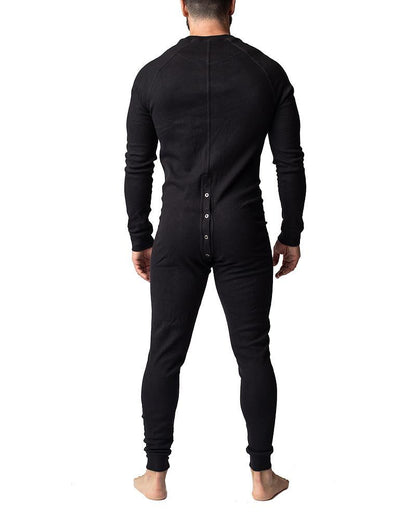 Black long-sleeved one-piece thermal union suit shown from the back with a button-down closure for warmth