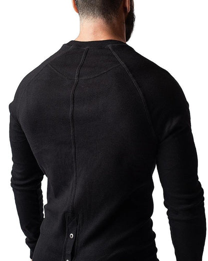 Black ribbed long-sleeve thermal union suit with crew neck and back button detail showing the back side