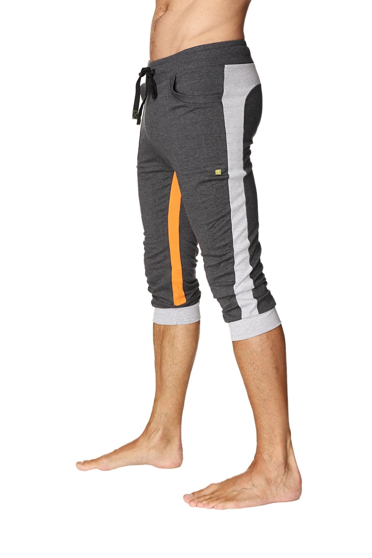 Ultra-flex tri-color cuffed yoga pant in charcoal with gray and orange featuring a black drawstring waistband and ribbed cuffs