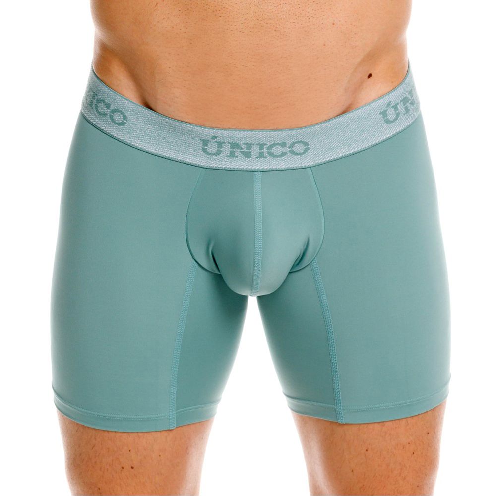 Teal-colored form-fitting ceramic boxer briefs with textured gray waistband featuring único brand logo color 43-green