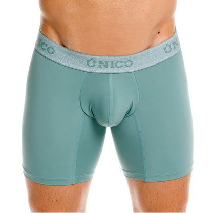 Teal-colored form-fitting ceramic boxer briefs with textured gray waistband featuring único brand logo color 43-green