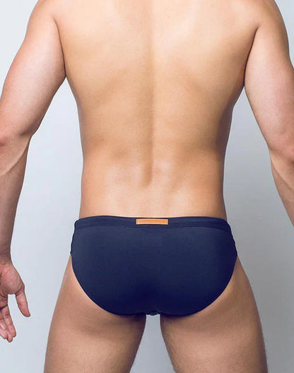 Navy blue v10 core bikini briefs with small tan rectangular tag on the waistband designed for comfortable wear