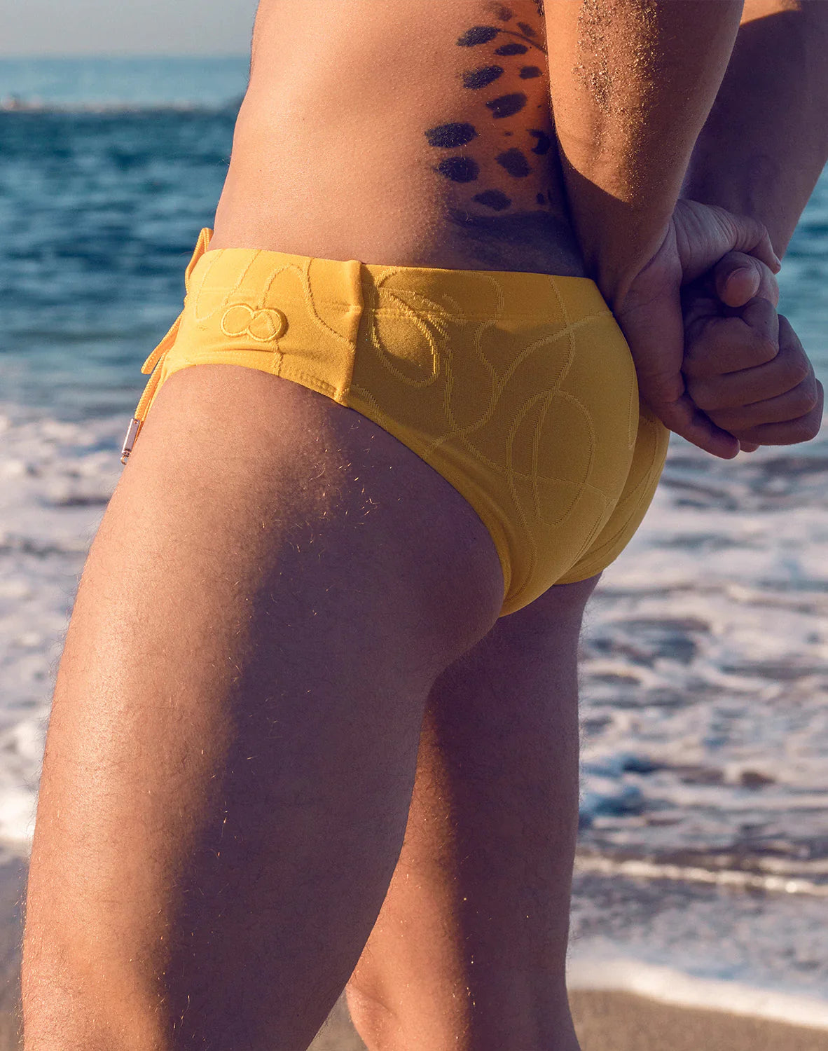 Bright yellow V10 ripple textured swim brief with subtle embroidered pattern and side ties for beachwear