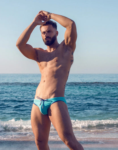 V22 rapid swim brief in vibrant turquoise with contrasting dark blue drawstring for comfortable swimwear fit