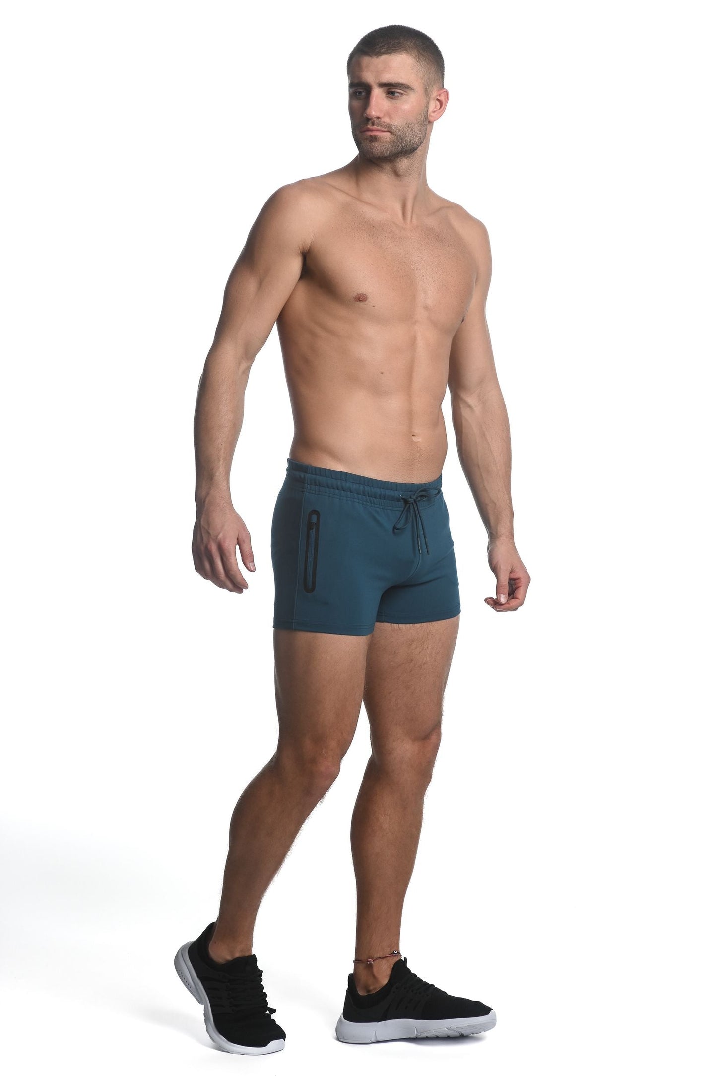 Teal vault gym-tech stretch shorts with heat weld zippers featuring drawstring waist and side zipper pockets