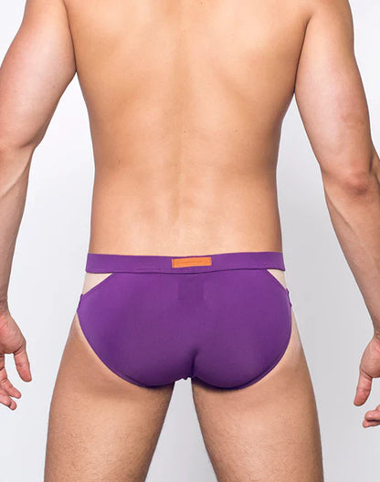 Purple VB21 BLK LABEL swim brief with contrasting orange rectangular tag on waistband designed for athletic use