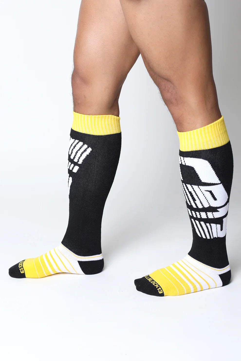 Velocity 2.0 knee high socks in black and yellow with bold white graphic design perfect for athletic use