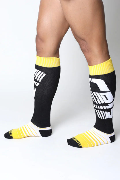 Velocity 2.0 knee high socks in black and yellow with bold white graphic design perfect for athletic use