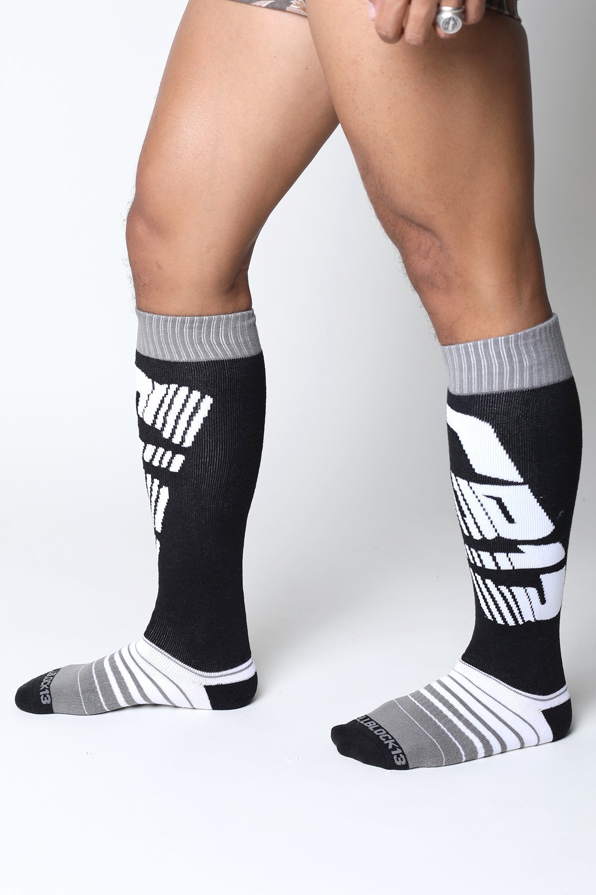 Black and gray velocity 2.0 knee high athletic socks with bold white graphic lettering for performance use