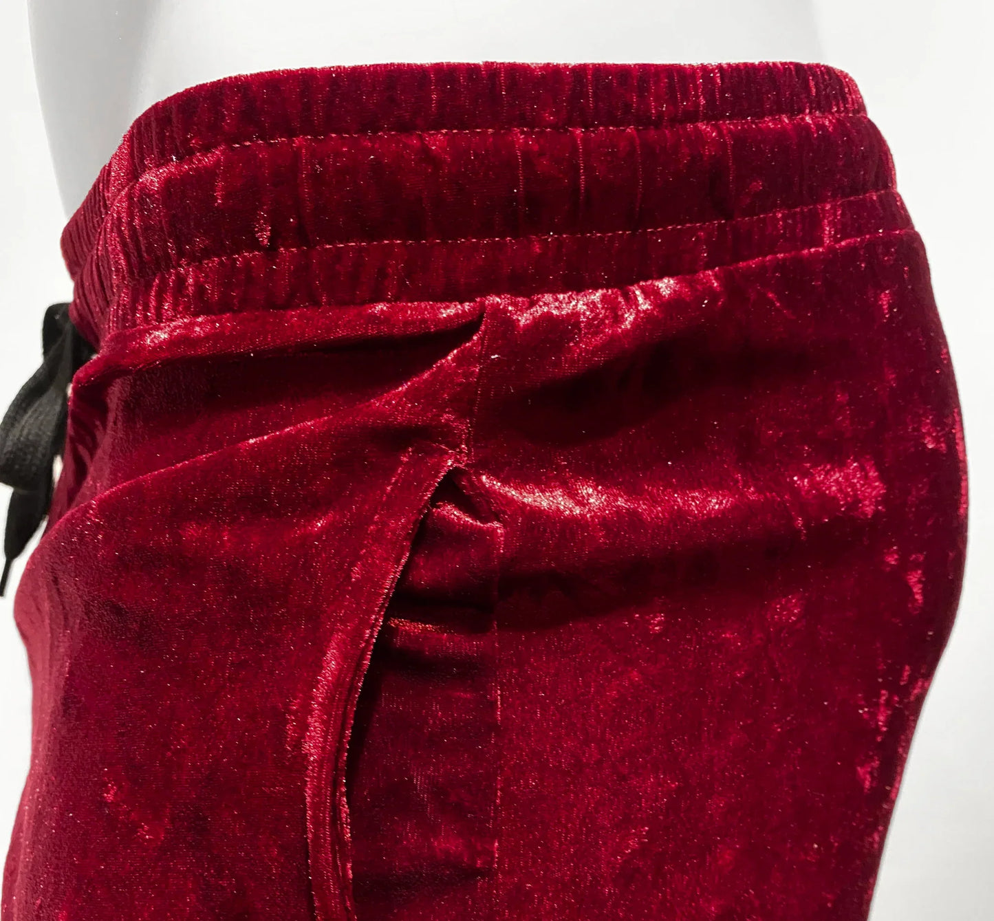 Velvet pocket shorts in rich crimson velvet with soft plush texture and elastic waistband for comfortable wear