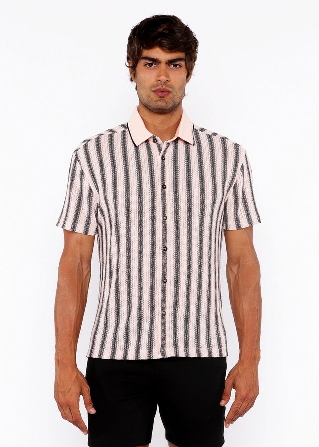 A man wearing a vertical stripe open stretch knit shirt with rib collar in black and off-white short sleeves