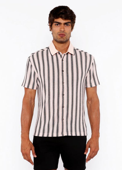 A man wearing a vertical stripe open stretch knit shirt with rib collar in black and off-white short sleeves