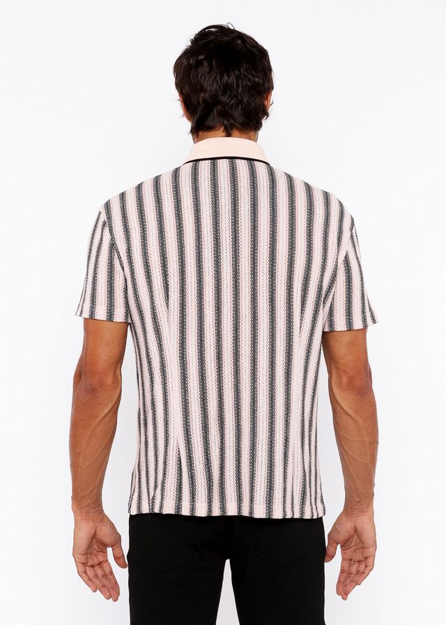 A man wearing a vertical stripe open stretch knit shirt with rib collar in black and off-white textured fabric