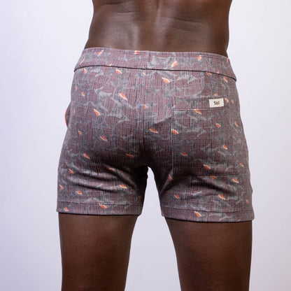 Back side of vintage stripes linen texture gray shorts with subtle weave and orange fish motifs with branded label