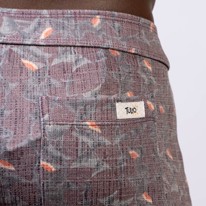 Back side of vintage stripes linen texture shorts in purple and gray with orange leaf accents and tulo label on pocket
