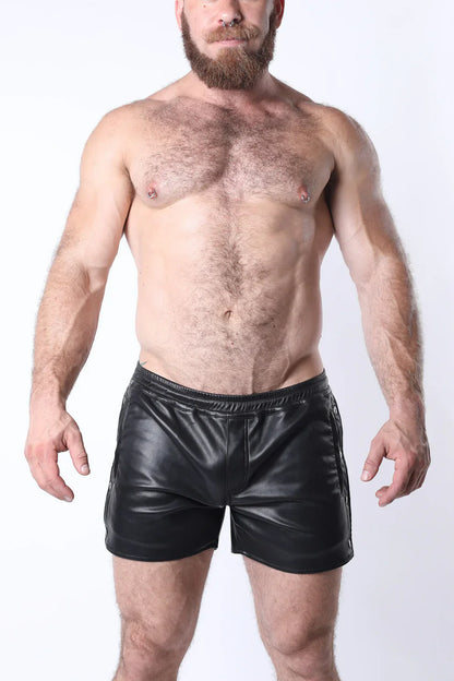 Black faux leather void snap up short with shiny smooth texture and side zippers for edgy style