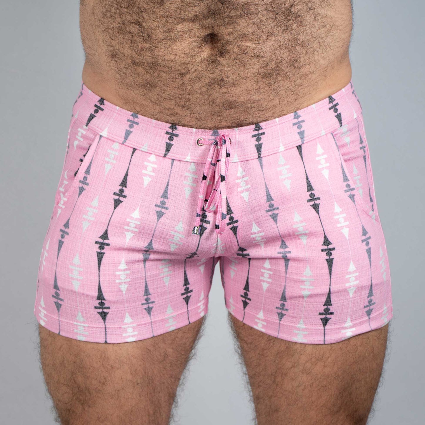 Pink wallpaper print linen texture shorts with black and white geometric arrow pattern and drawstring waistband