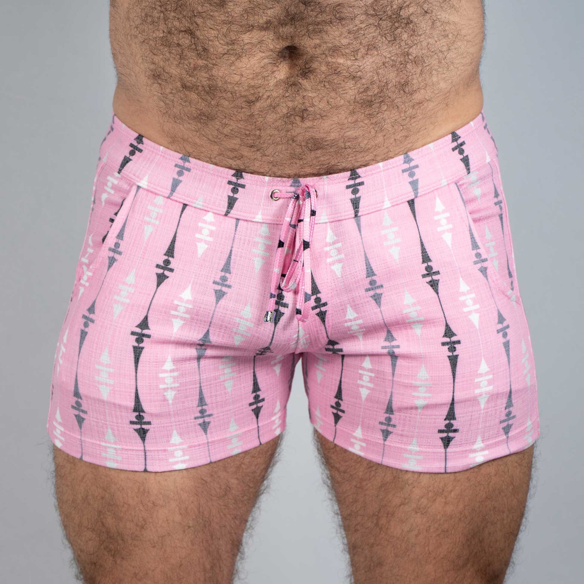 Pink wallpaper print linen texture shorts with black and white geometric arrow pattern and drawstring waistband