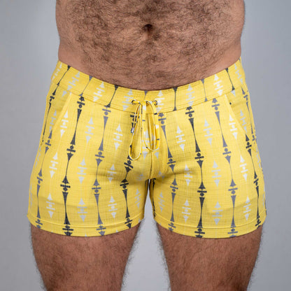 Bright yellow wallpaper print linen texture shorts with black and white geometric pattern and matching drawstring waistband