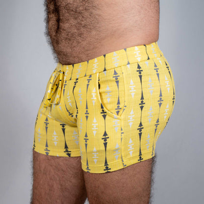 Bright yellow wallpaper print linen texture shorts with bold black and white geometric pattern and elastic waistband