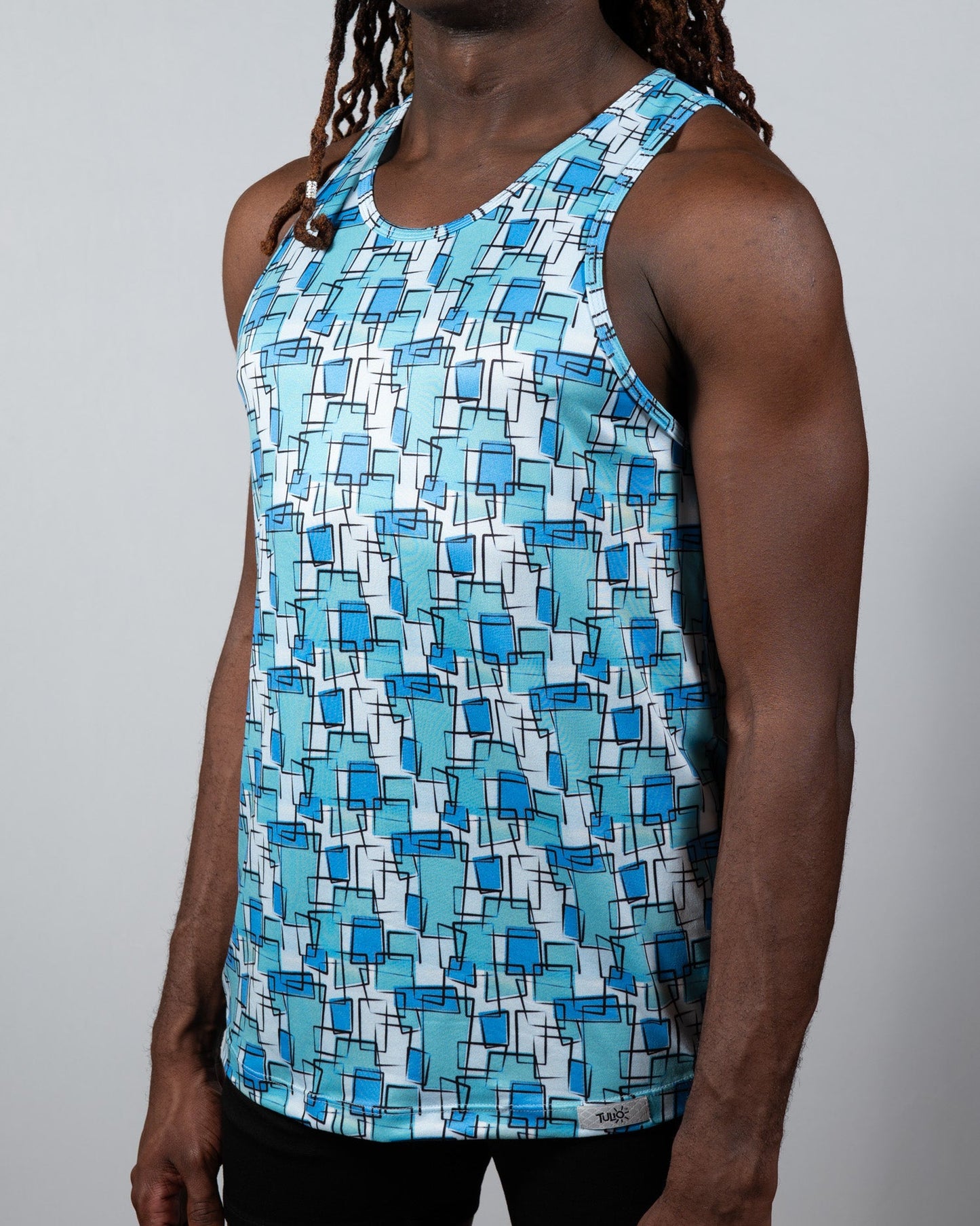 A men’s wallpaper print tank with overlapping blue squares on white lightweight fabric perfect for summer wear