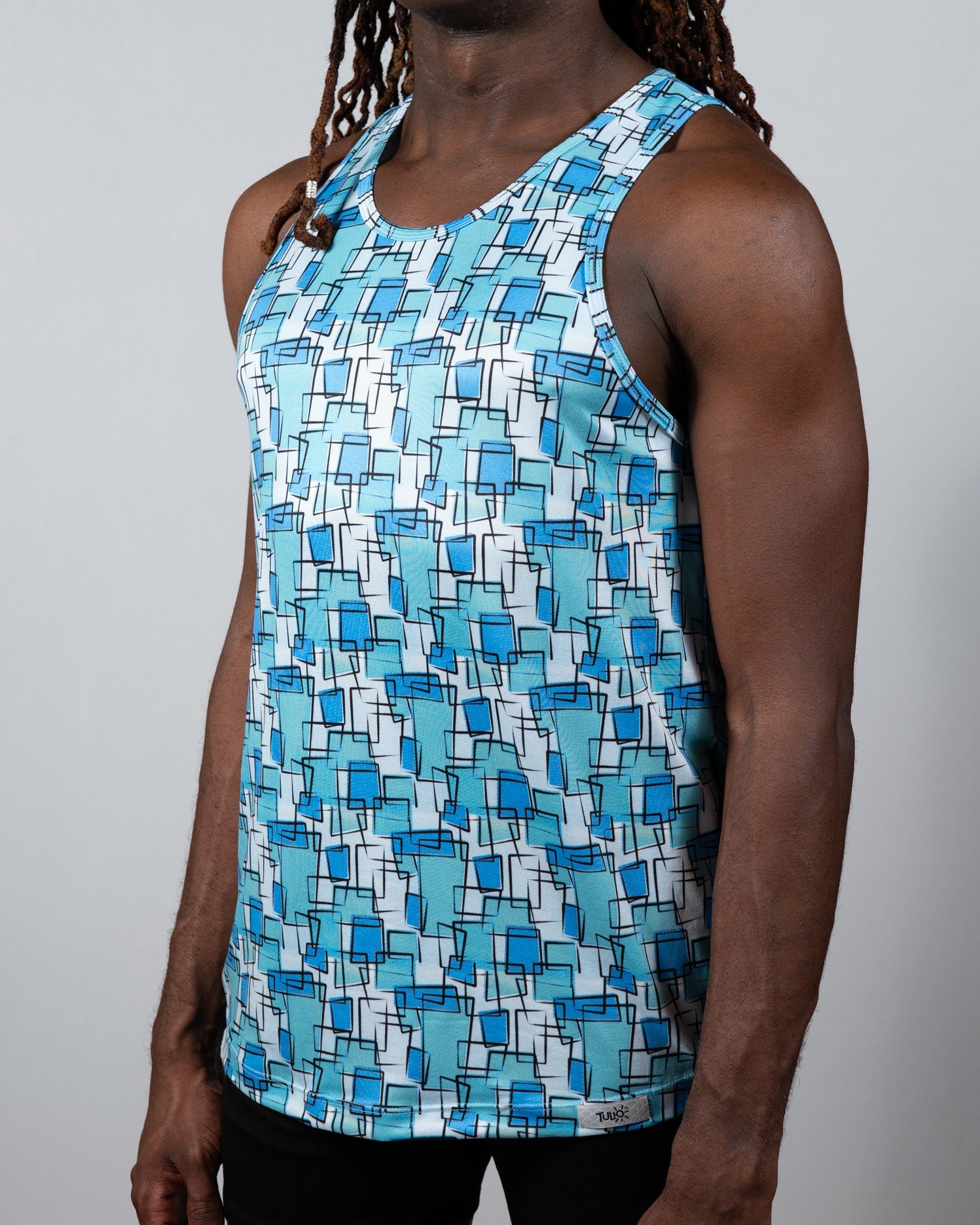 A men’s wallpaper print tank with overlapping blue squares on white lightweight fabric perfect for summer wear