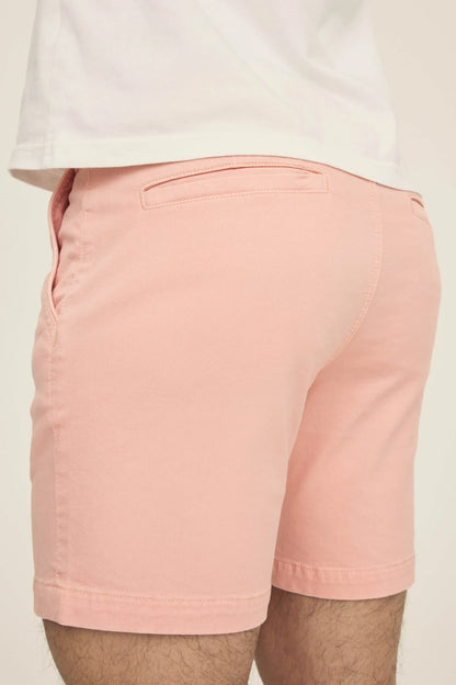 Back view of pink chino shorts paired with a white t-shirt.