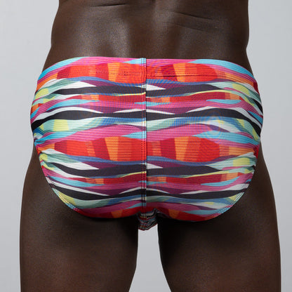 Waves print brief swim trunks with vibrant multicolored abstract stripes in pink orange blue and black