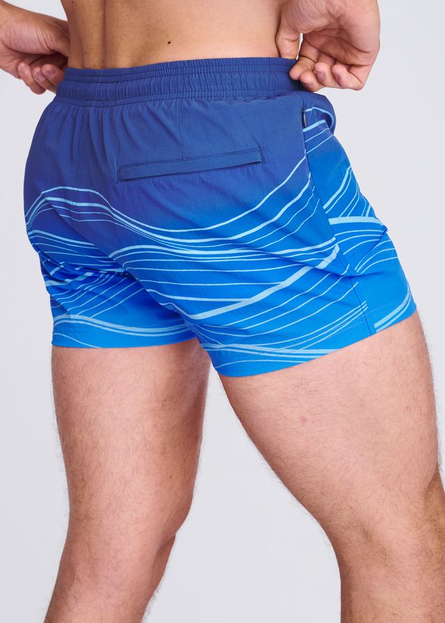 Blue waves print swim shorts with white wavy line pattern and mesh lining for comfortable beachwear
