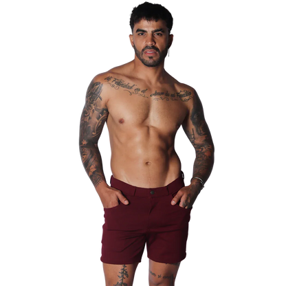Wine-colored tailored shorts featuring a flat front, button closure, and slim-fit silhouette.