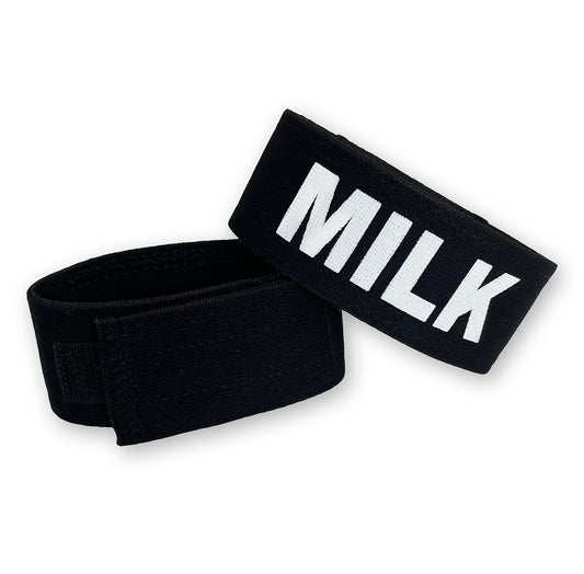 Two black adjustable elastic cock rings, one featuring the word "MILK" in bold white lettering against a white background.
