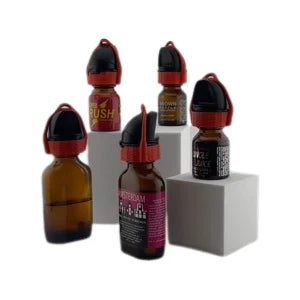 Several amber glass essential oil bottles with black and red caps labeled wyffr topper for aromatherapy use