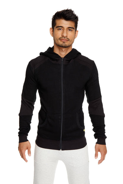 Black mid-weight luxury-fleece zip-up hoodie with subtle contrast sleeve panels and yellow tag for yoga and track use