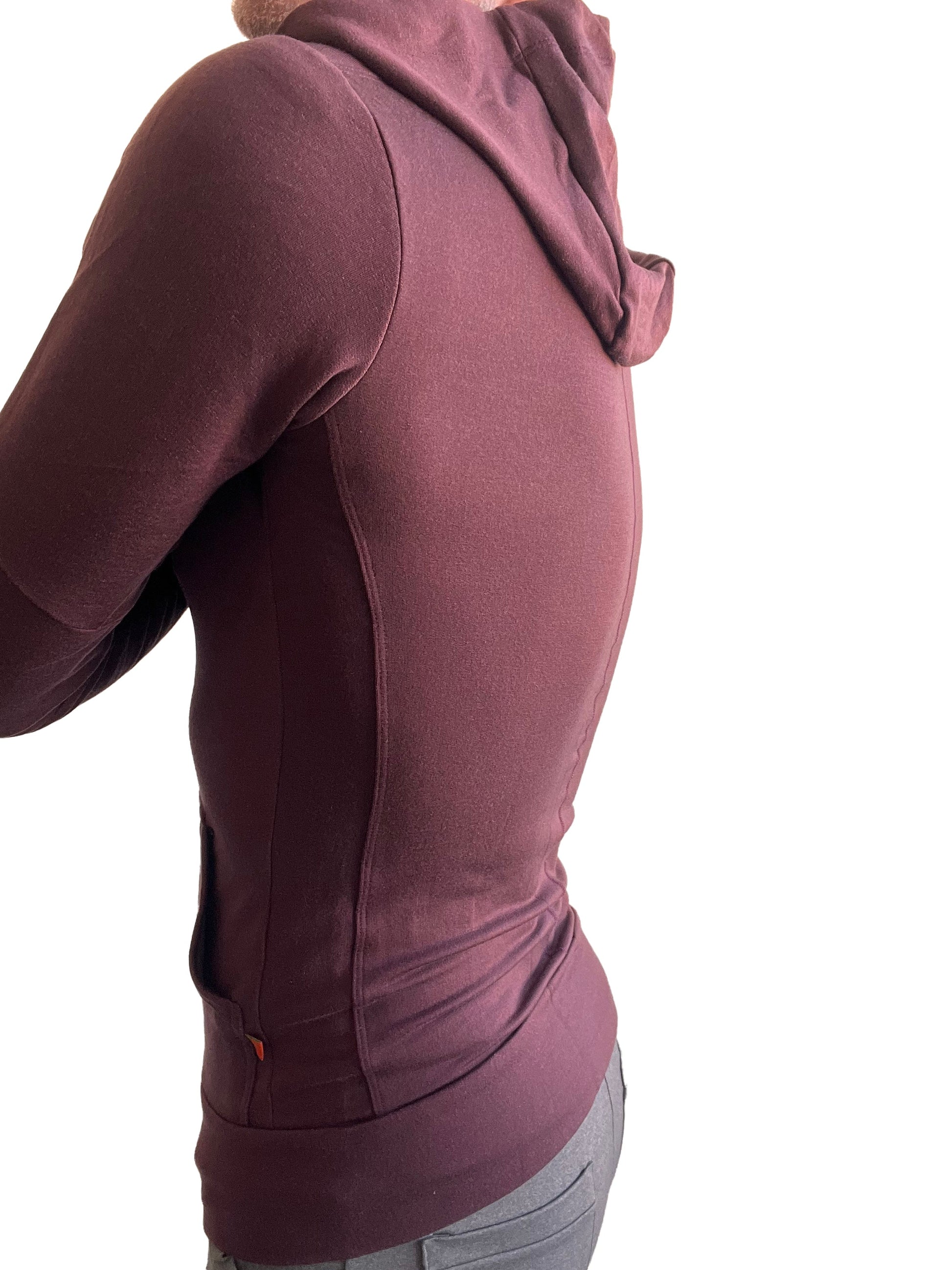 A maroon mid-weight luxury-fleece form-fit crossover yoga track hoodie with soft textured fabric and subtle seam detailing