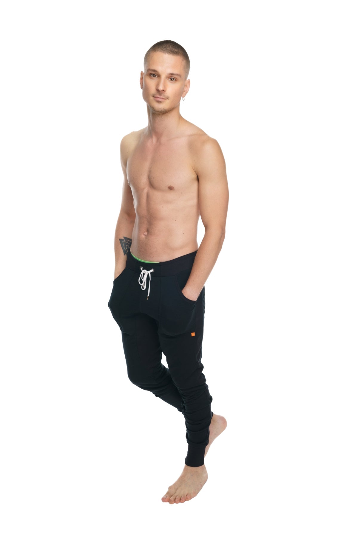 Black luxury-fleece long cuffed jogger pants with white drawstring and subtle orange logo on lower leg winter edition