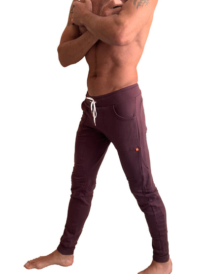 Purple luxury-fleece long cuffed joggers with white drawstrings and orange logo for winter edition activewear
