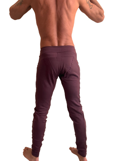 A pair of form-fitting deep burgundy winter edition luxury-fleece jogger and yoga sweat pants with high waistband and side seam detailing