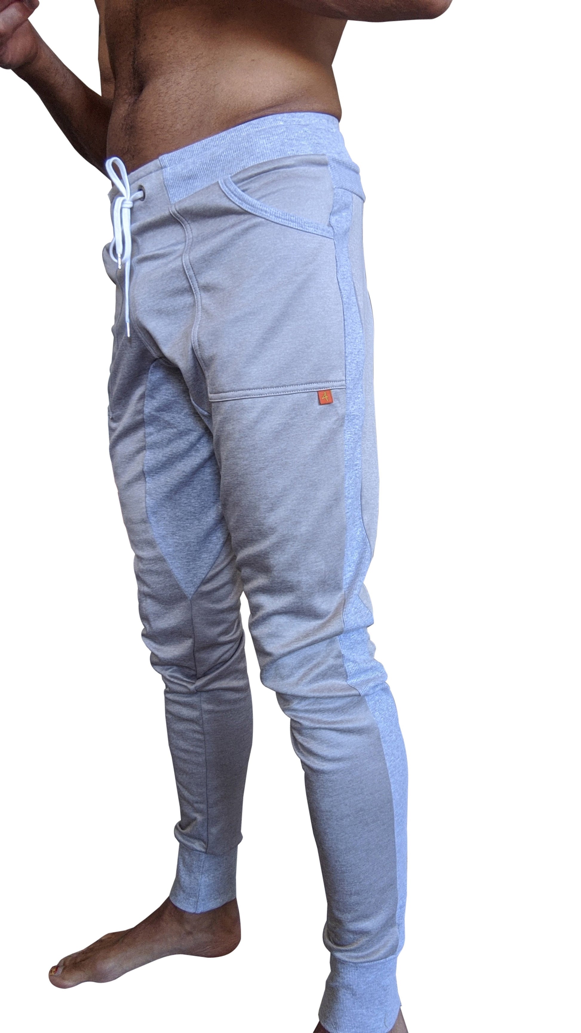 Light gray winter edition performance-luxe-fleece joggers with white drawstrings and orange brand tag on thigh