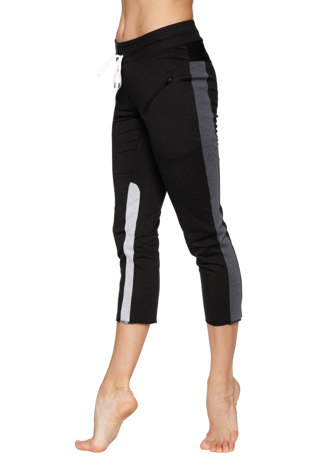 Women’s black capri yoga pants with gray and white side stripes and drawstring waistband for athletic wear