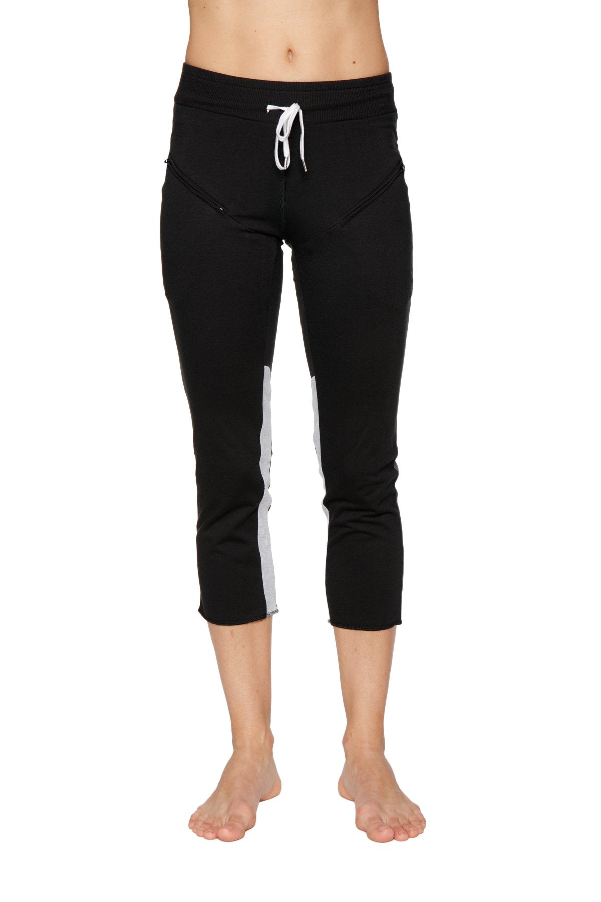 Black 4/5 length zipper pocket capri yoga pants with white side stripes and matching drawstring waistband for women