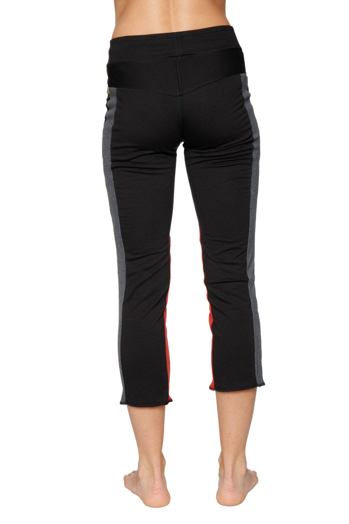 Women’s black capri yoga pants with charcoal and red side panels and zipper pocket for active wear