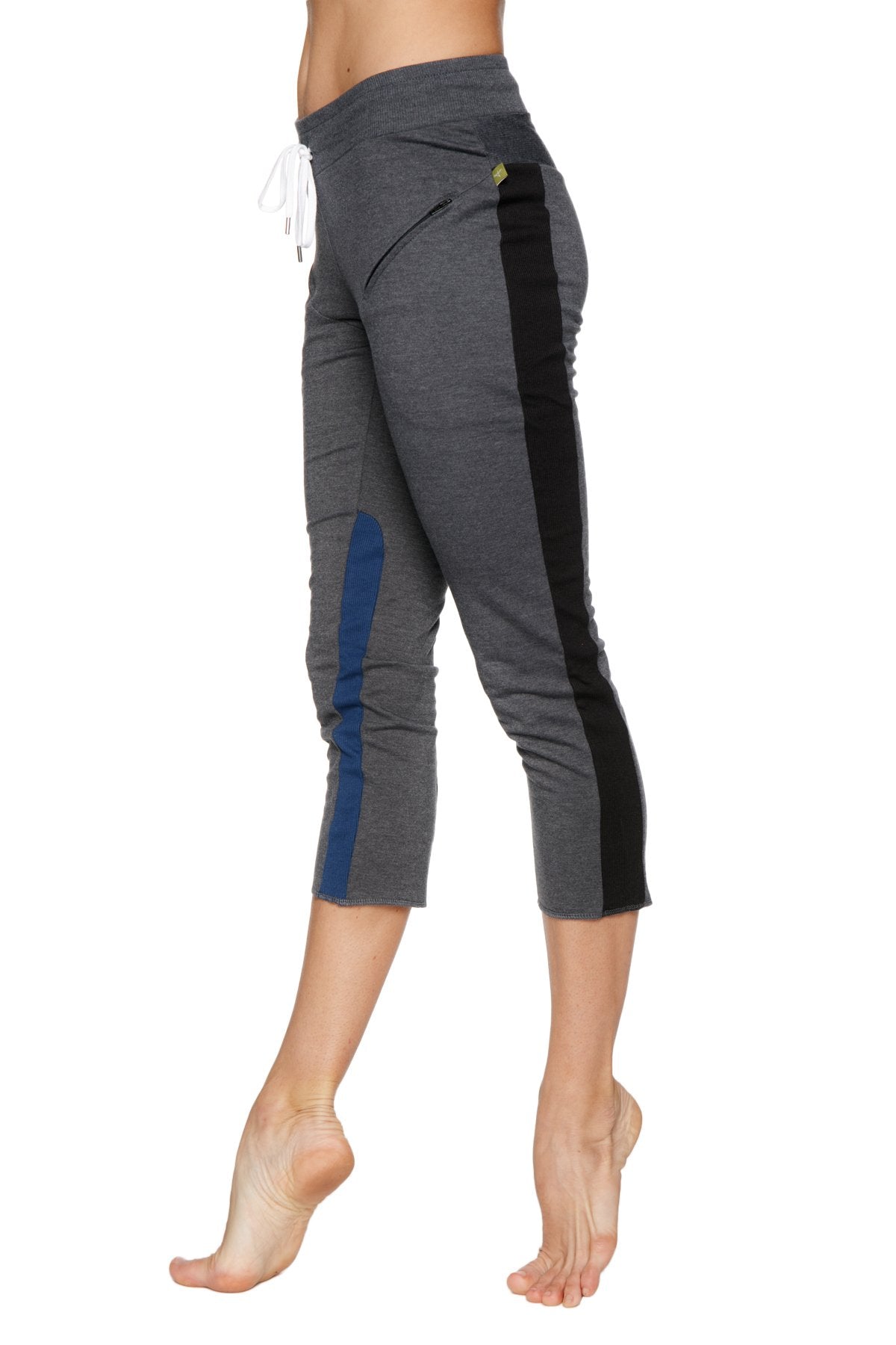Women’s charcoal gray 4/5 length zipper pocket capri yoga pant with black and blue side panels and drawstring waistband
