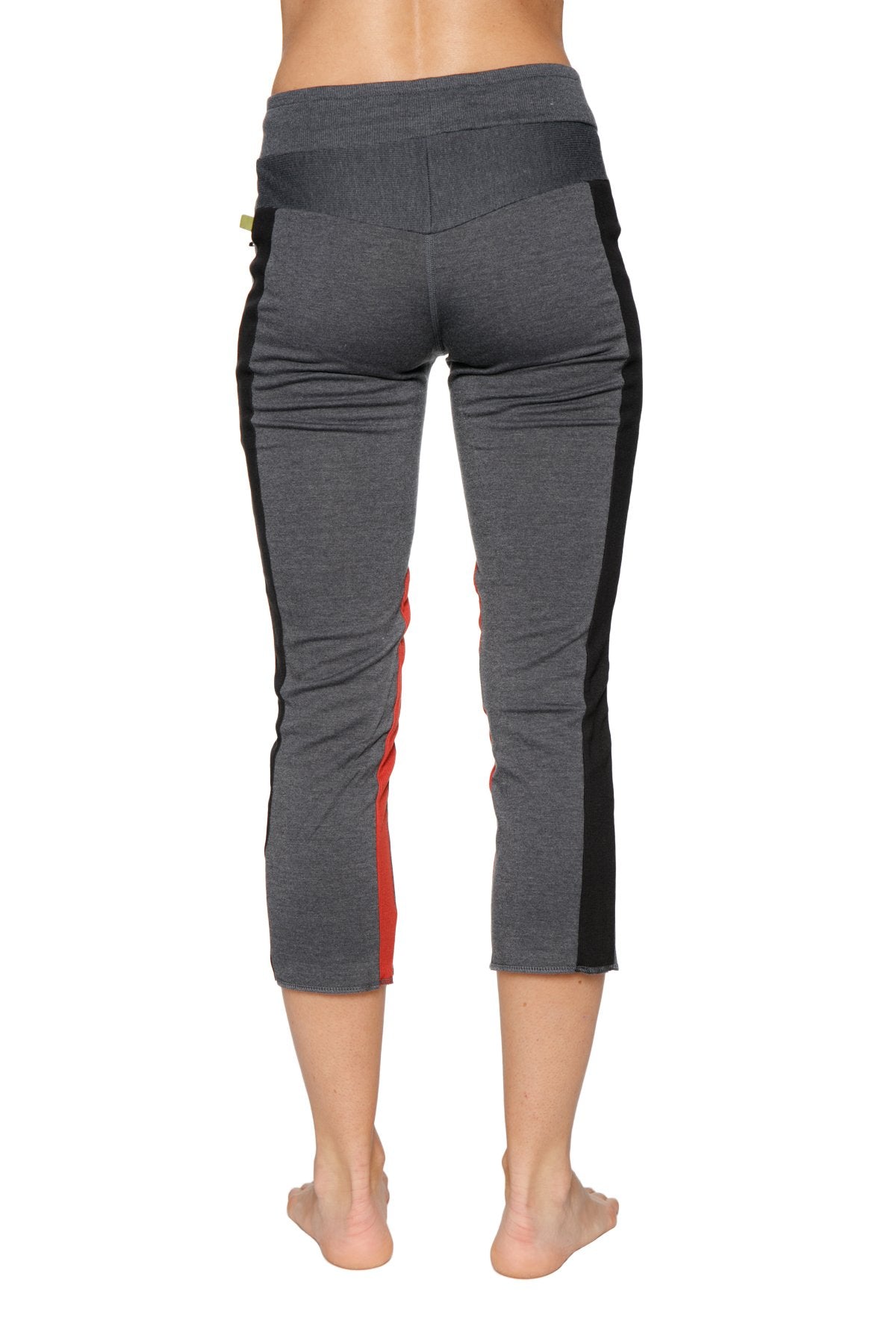 Women’s charcoal capri yoga leggings with black and red side panels and zipper pocket detail for active wear