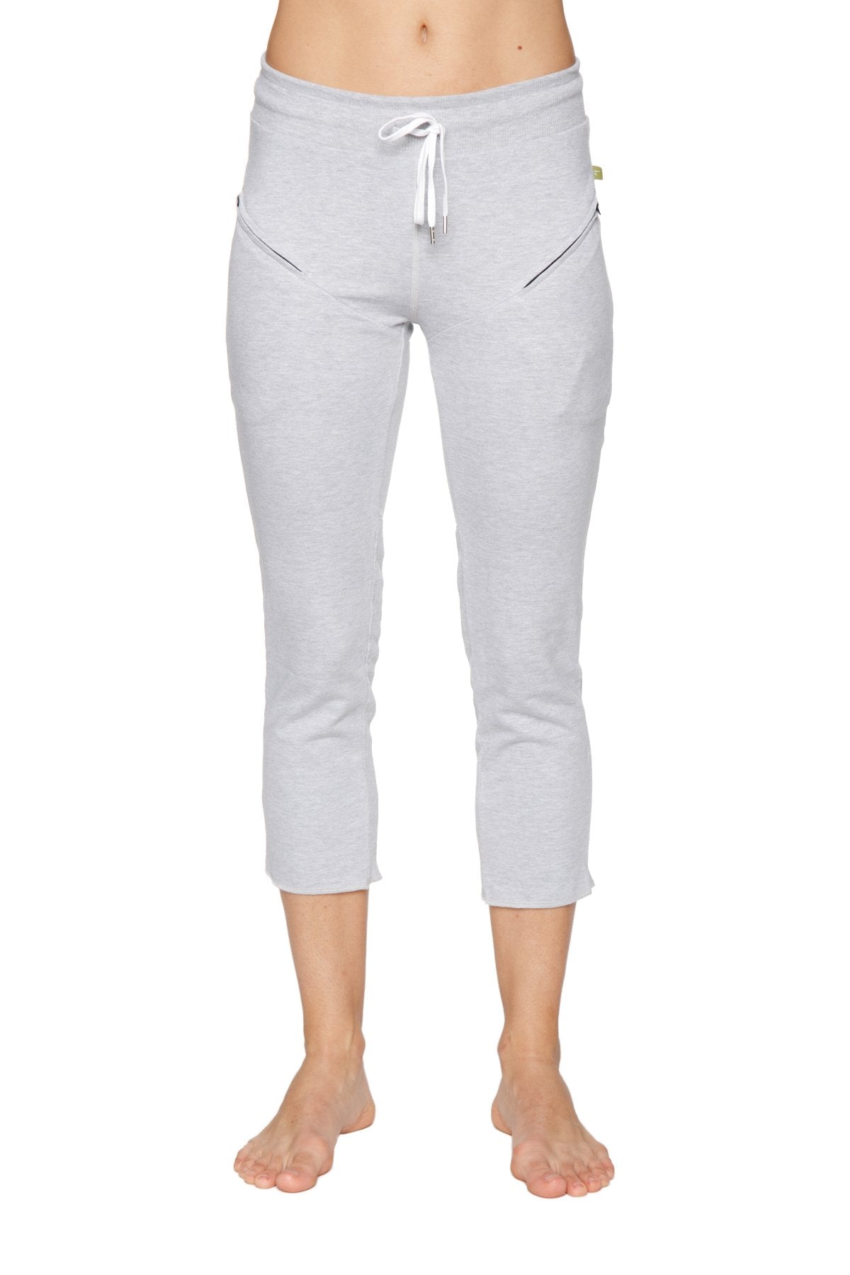 Light gray women’s 4/5 length capri yoga pants with white drawstring waistband and diagonal zipper pockets