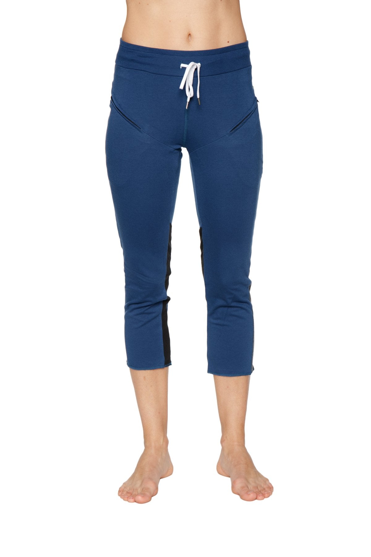 Women’s royal blue capri yoga pants with black side panels and white drawstring waistband featuring zipper pockets