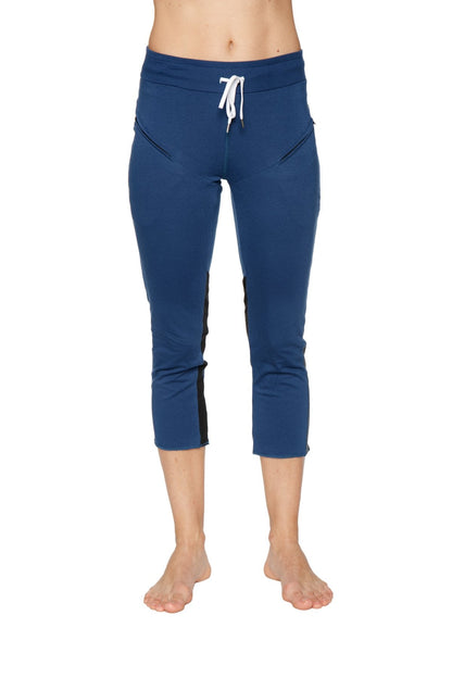 Women’s royal blue capri yoga pants with black side panels and white drawstring waistband featuring zipper pockets