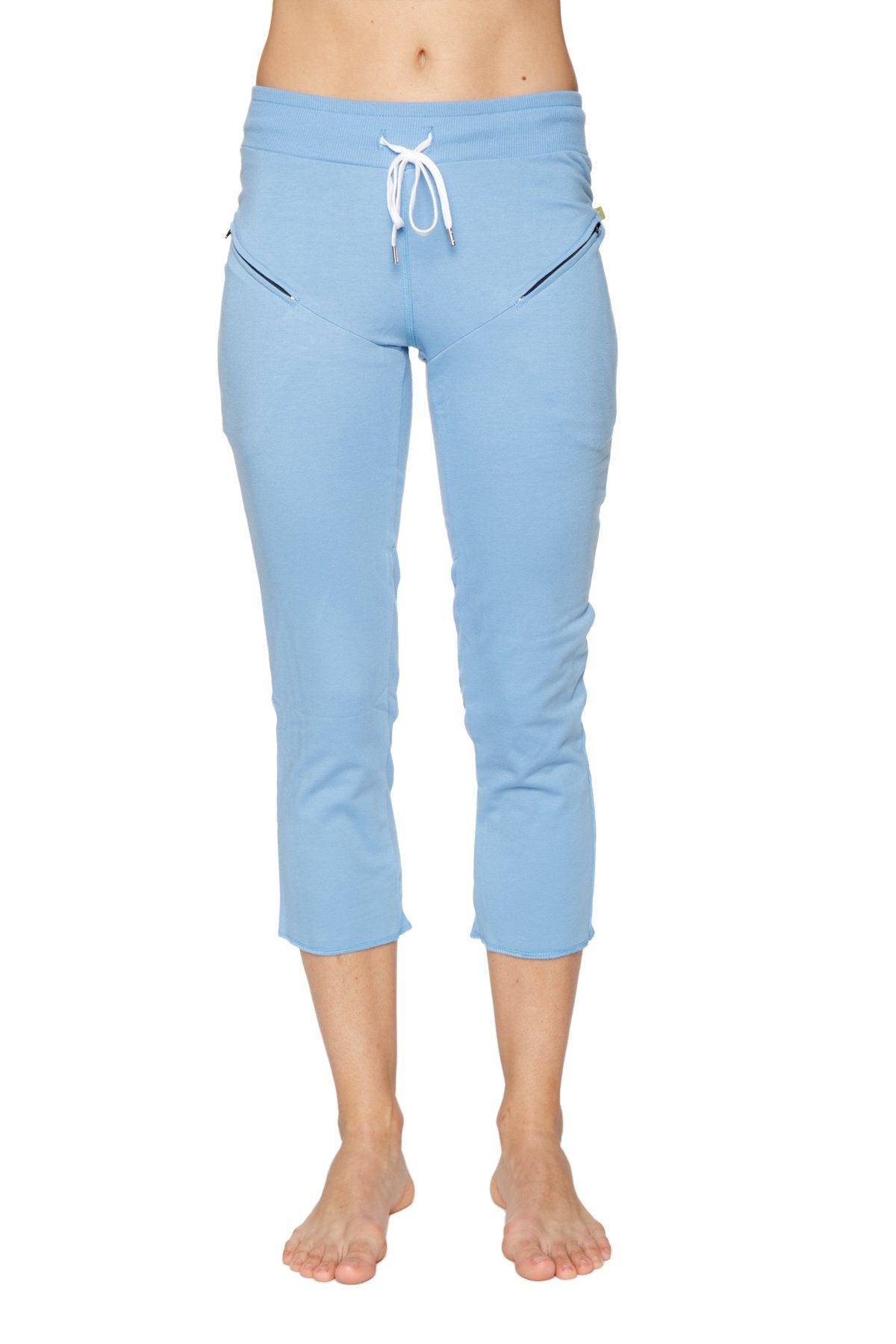 Light blue women’s 4/5 length capri yoga pants with white drawstring waistband and black zipper pockets