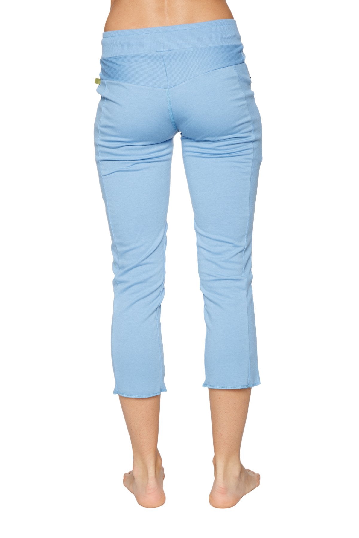 Women’s sky blue high-waisted 4/5 length capri yoga pants with stretchy fabric and subtle side ruching